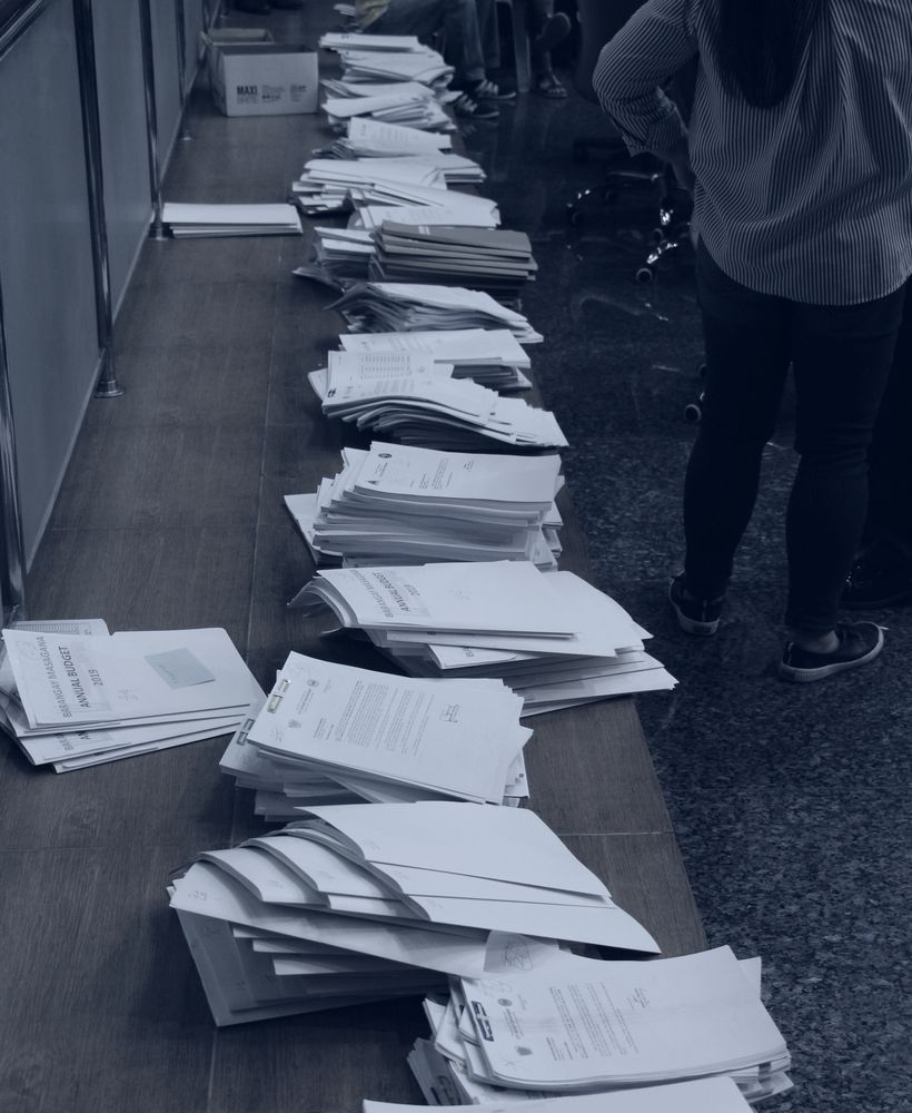 Stacked documentation files awaiting processing